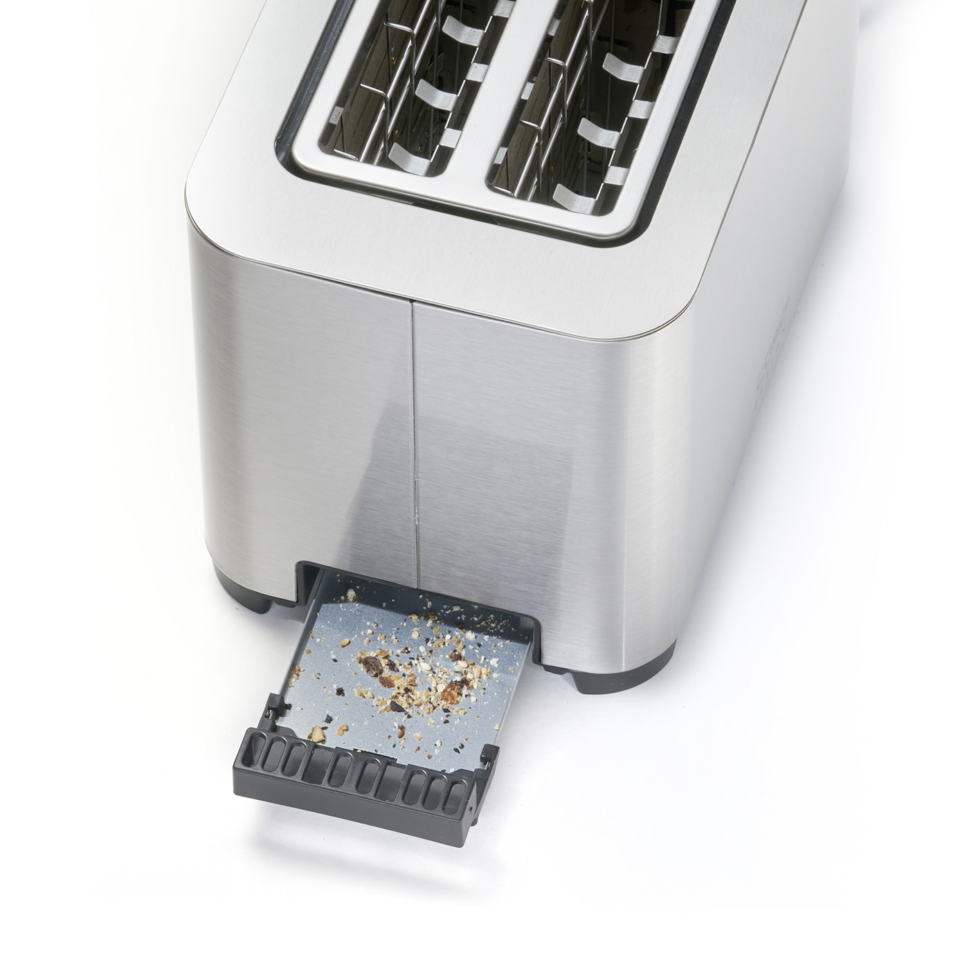 Close-up of a toaster with the crumb tray pulled out and bread crumbs