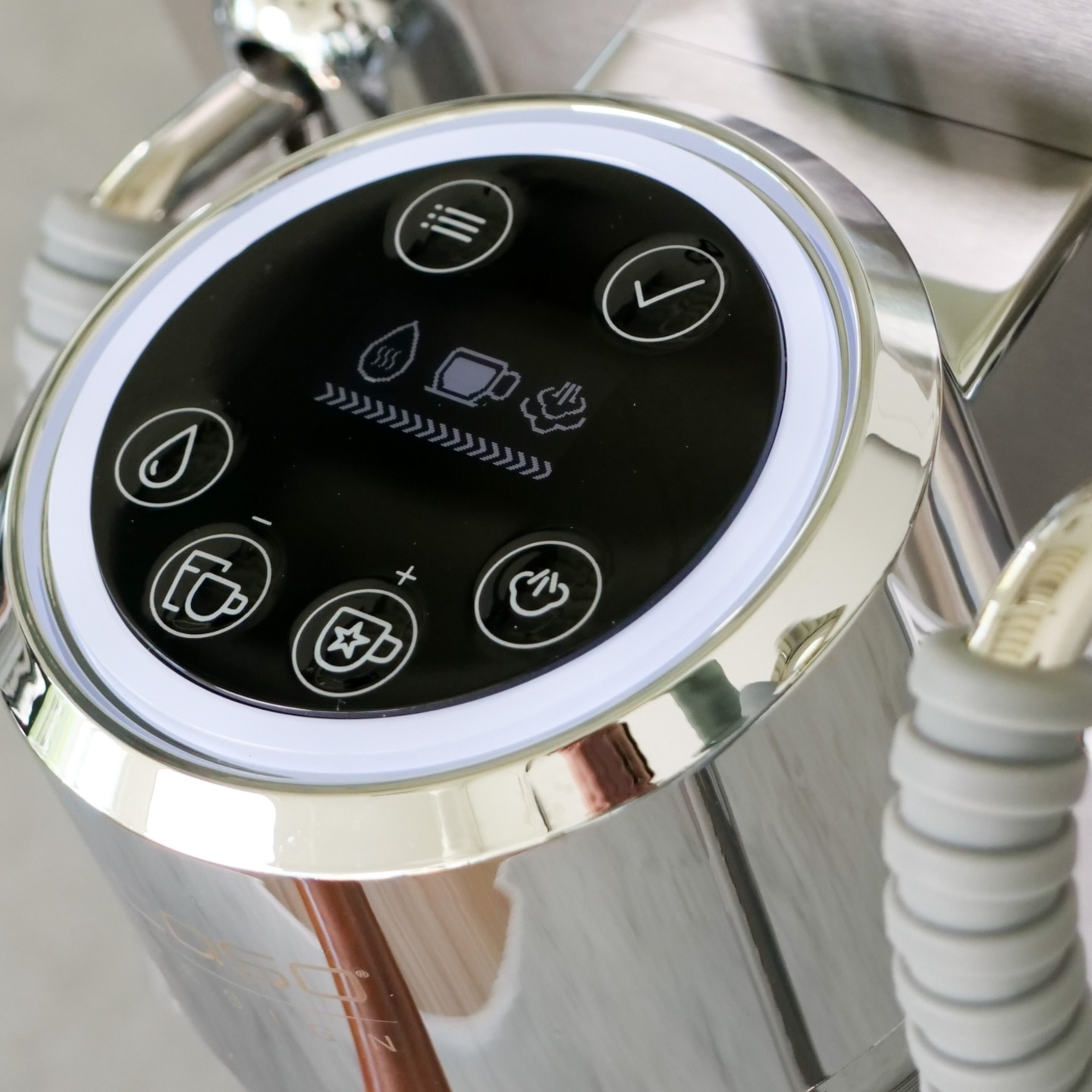 A silver espresso machine control panel with touch buttons and a digital display.