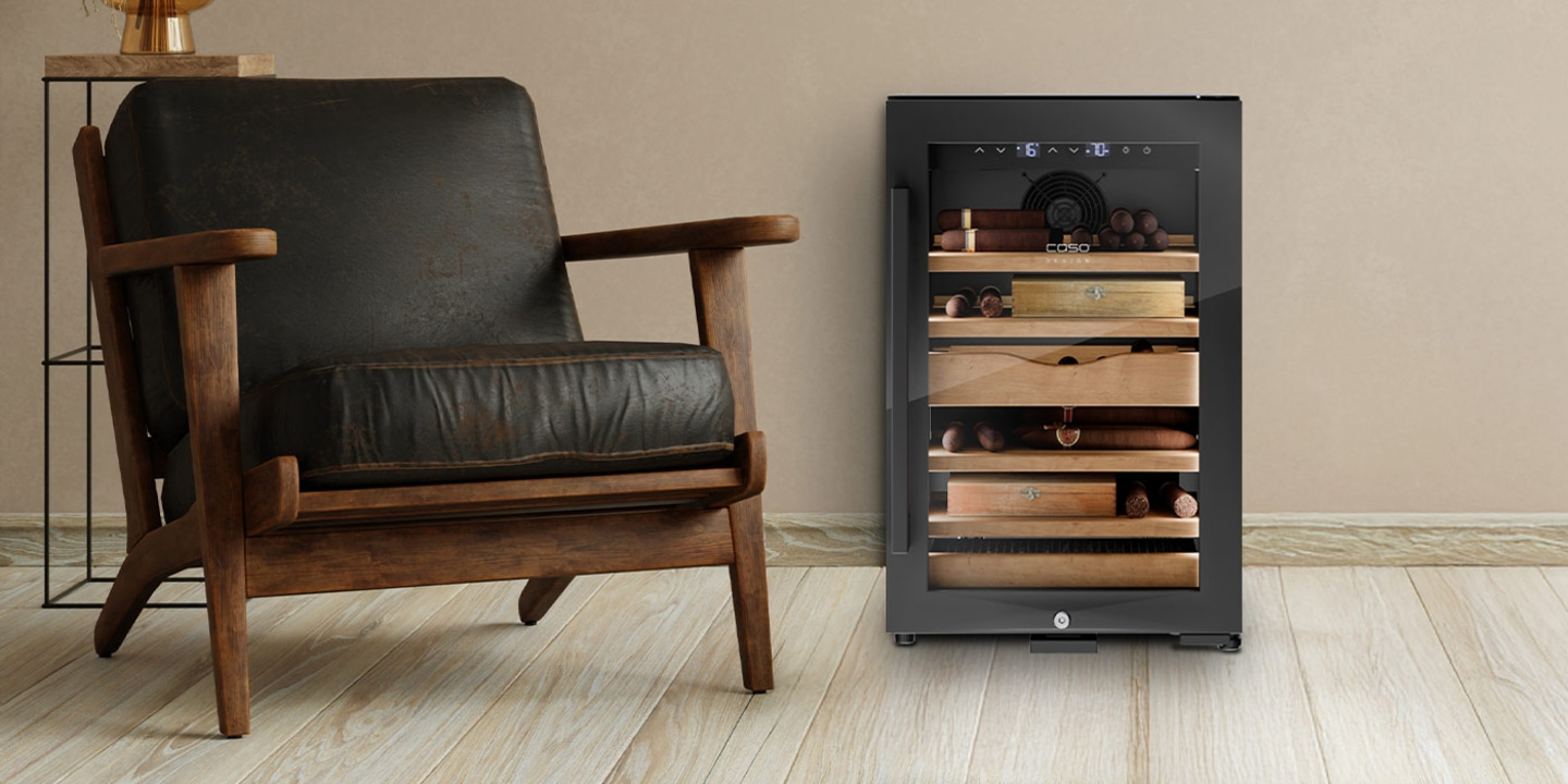 Leather armchair next to a cigar cooler on wooden floor.