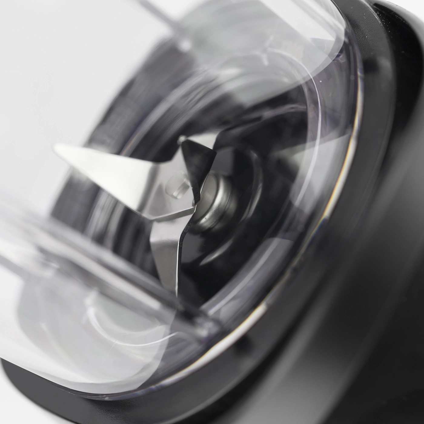 Close-up of a blender with sharp blades and a transparent container