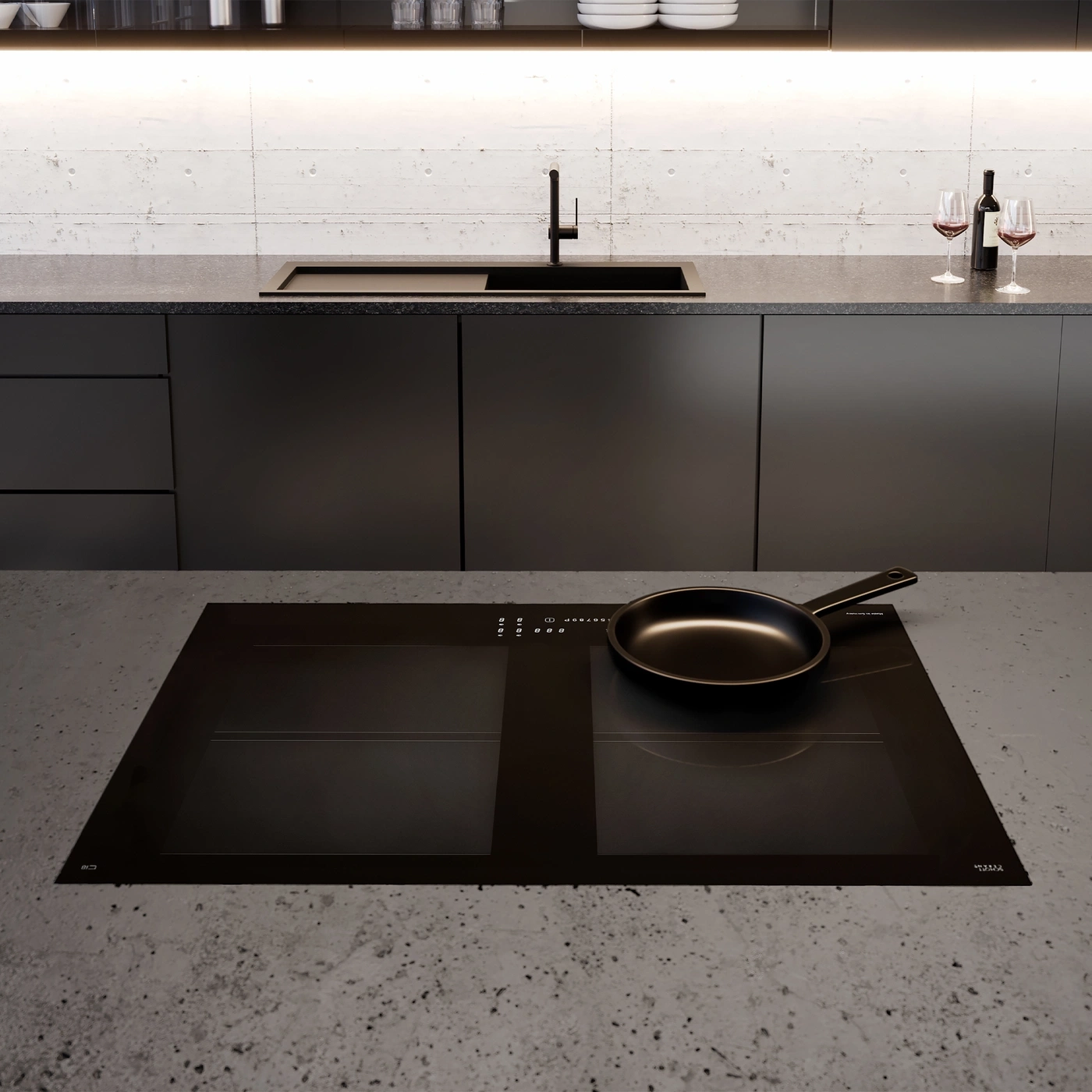 A modern induction hob with a frying pan and glasses of wine.