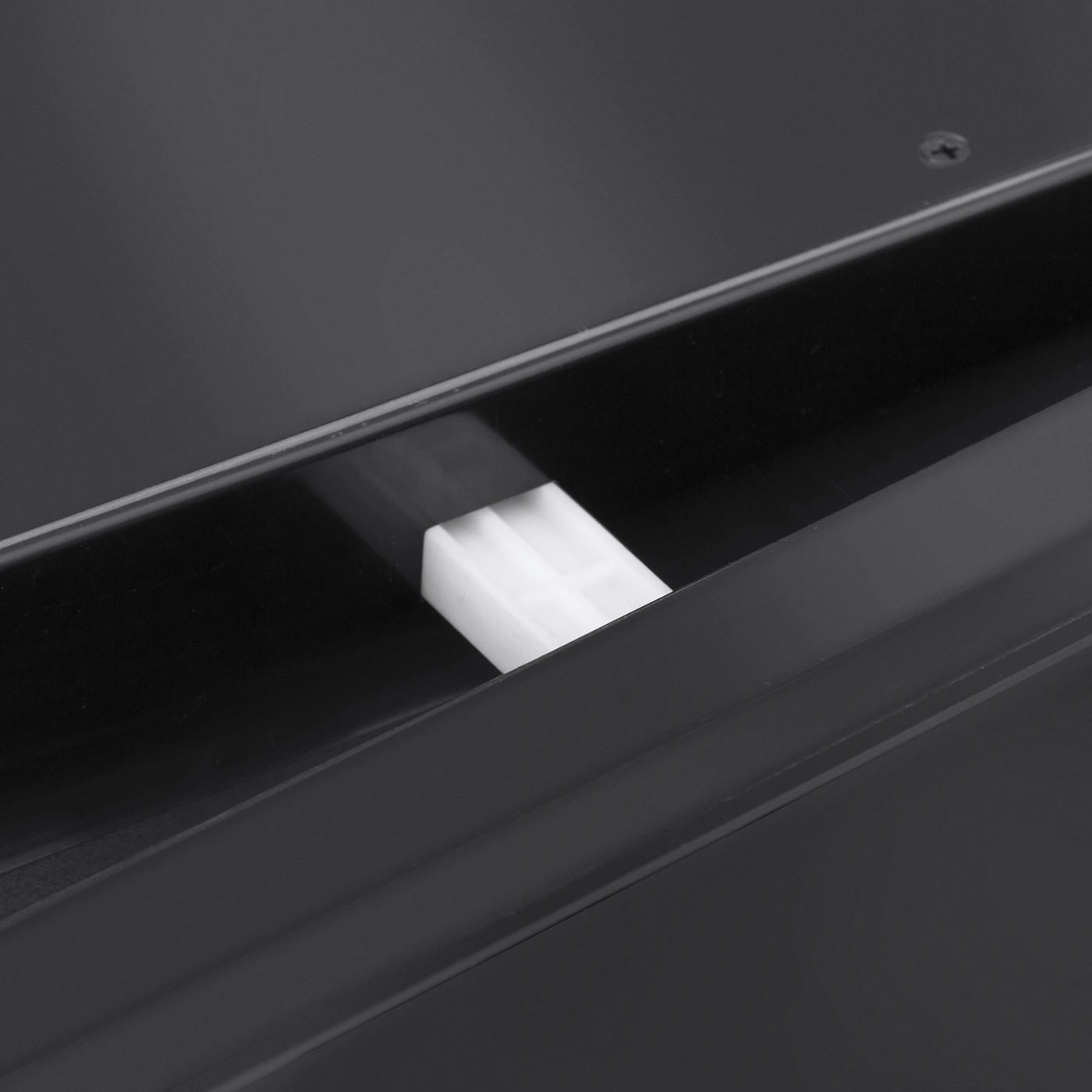 Close-up of a black object with a white rectangular part
