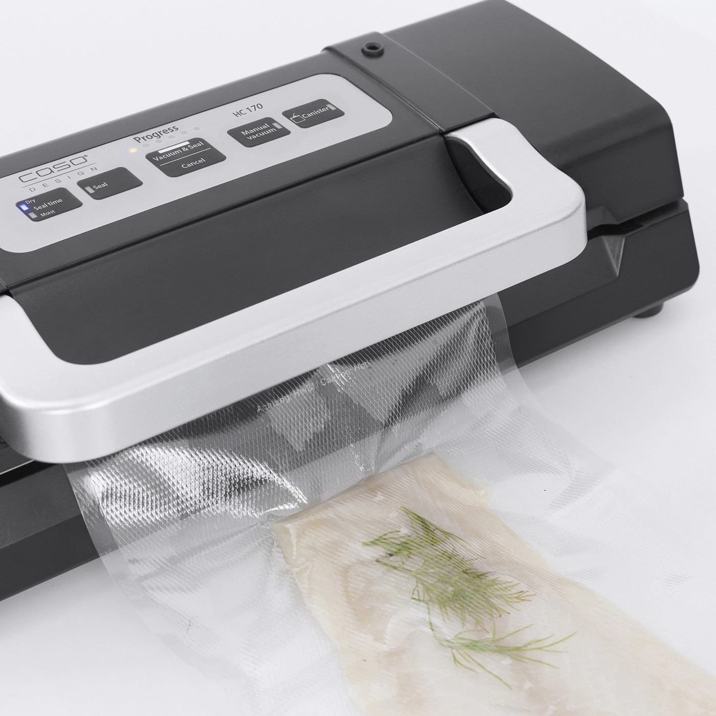 Vacuum sealer with vegetables in a bag, control panel with buttons and progress indicator.