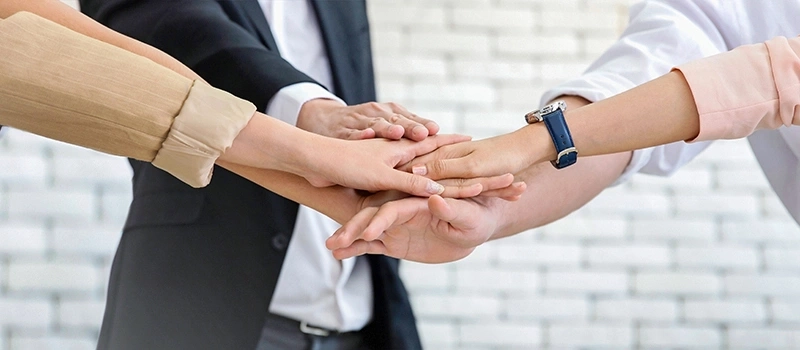 Teamwork concept: hands together to symbolize unity and collaboration in business.