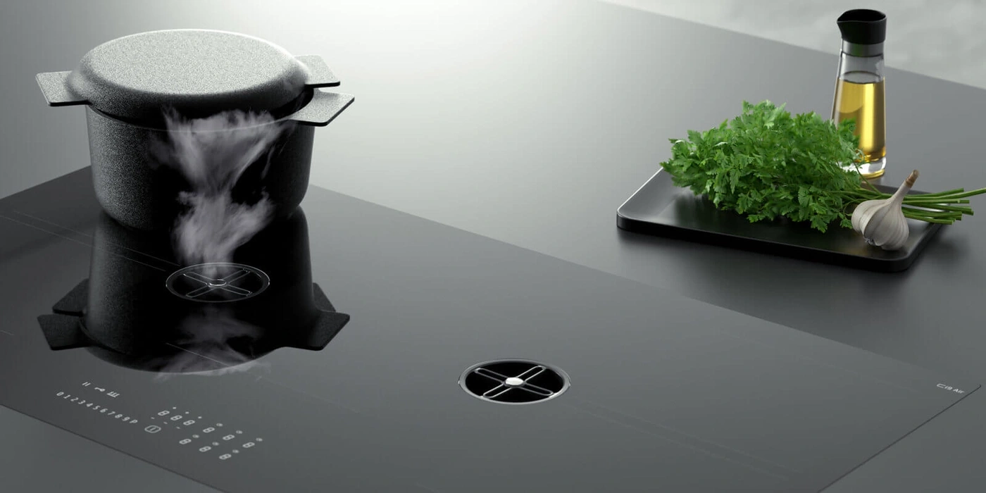 A pot with steam on an induction hob with herbs and oil.