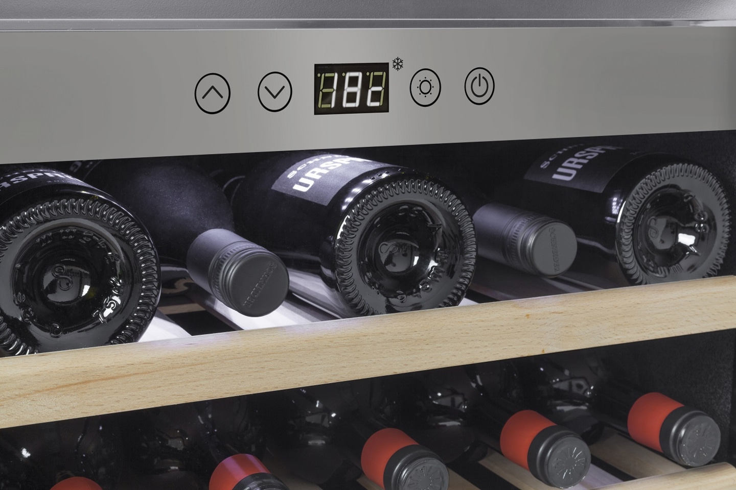Wine cooler with temperature display and wine bottles on the shelves.