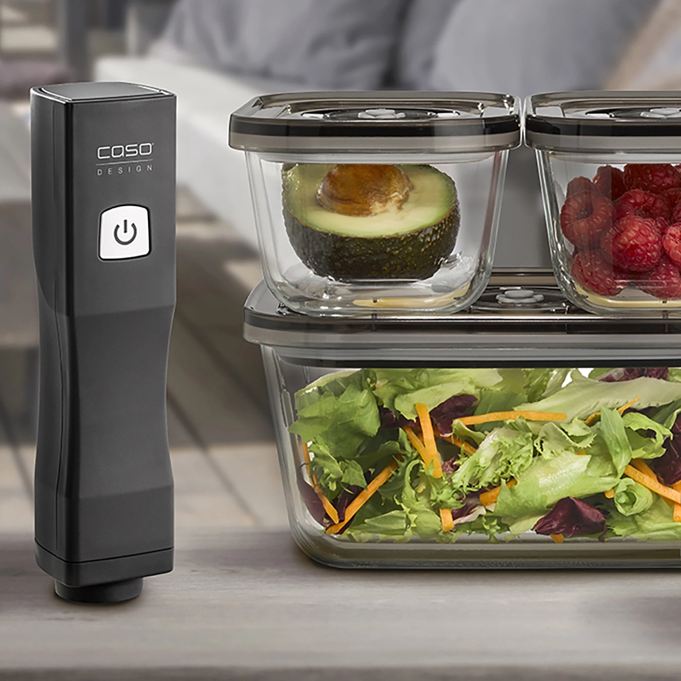 Vacuum sealer with containers, avocado, raspberries, and salad.