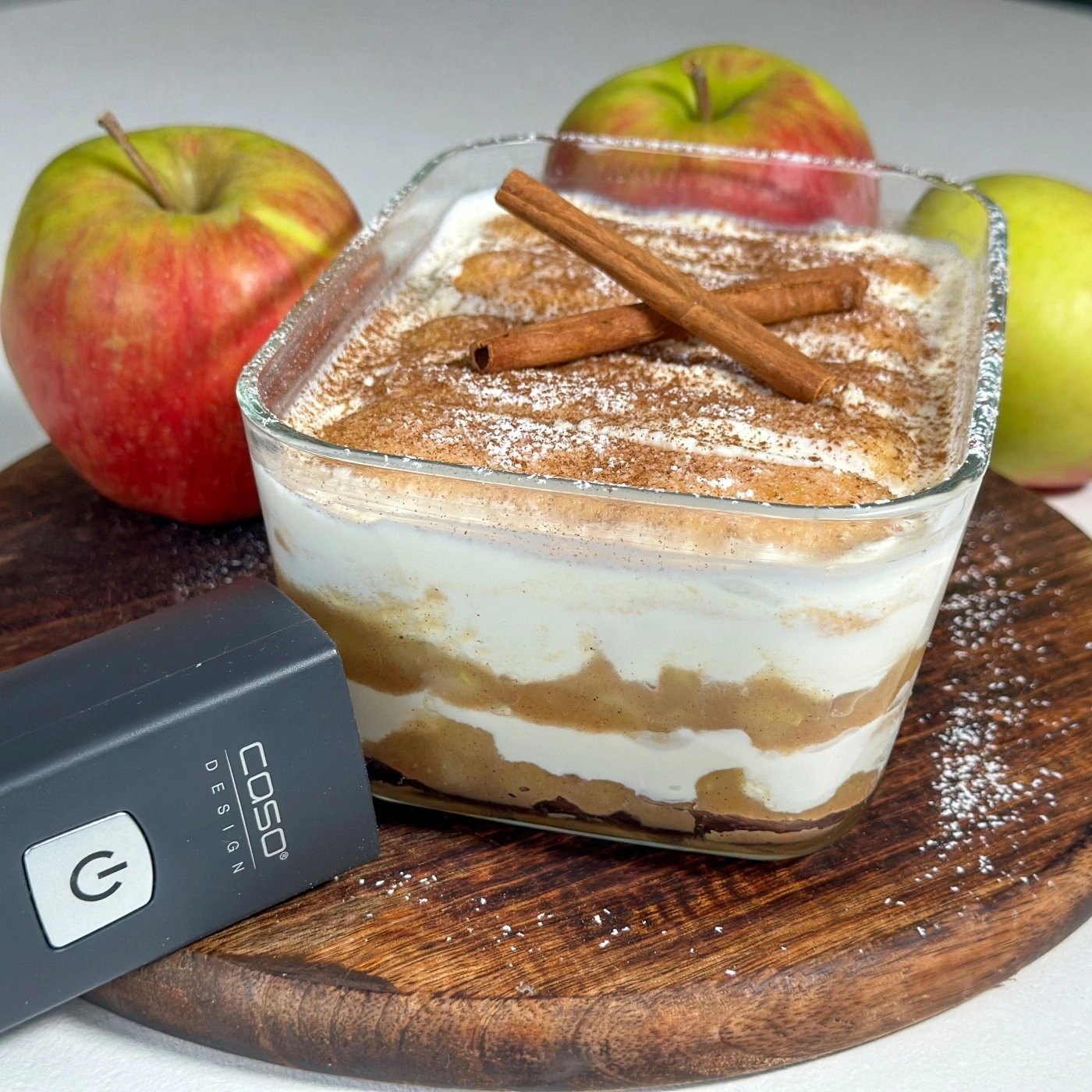 Apple tiramisu with cinnamon and apples on a wooden board