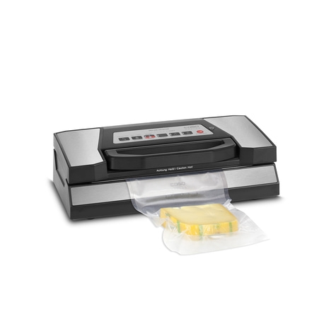Vacuum sealer with cheese in a bag, ready to seal. Food packaging machine.