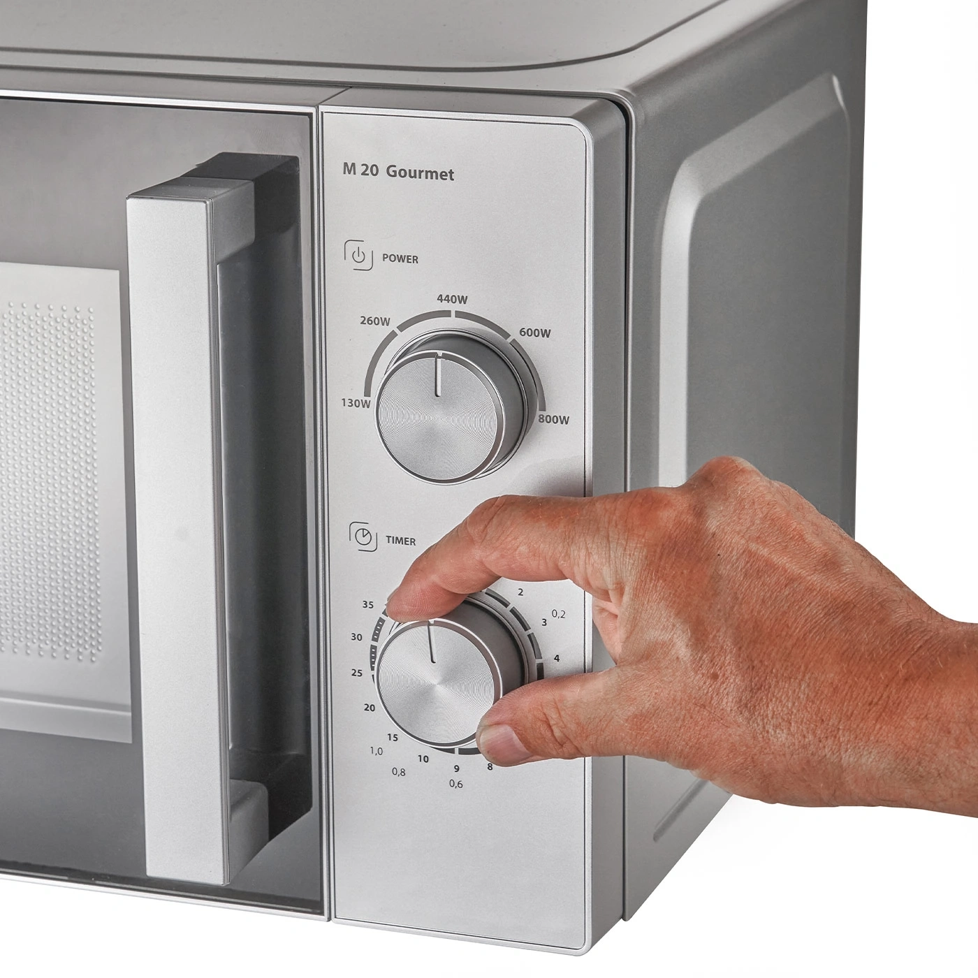 Microwave with controls, hand turning timer, gray surface, M 20 Gourmet appliance.