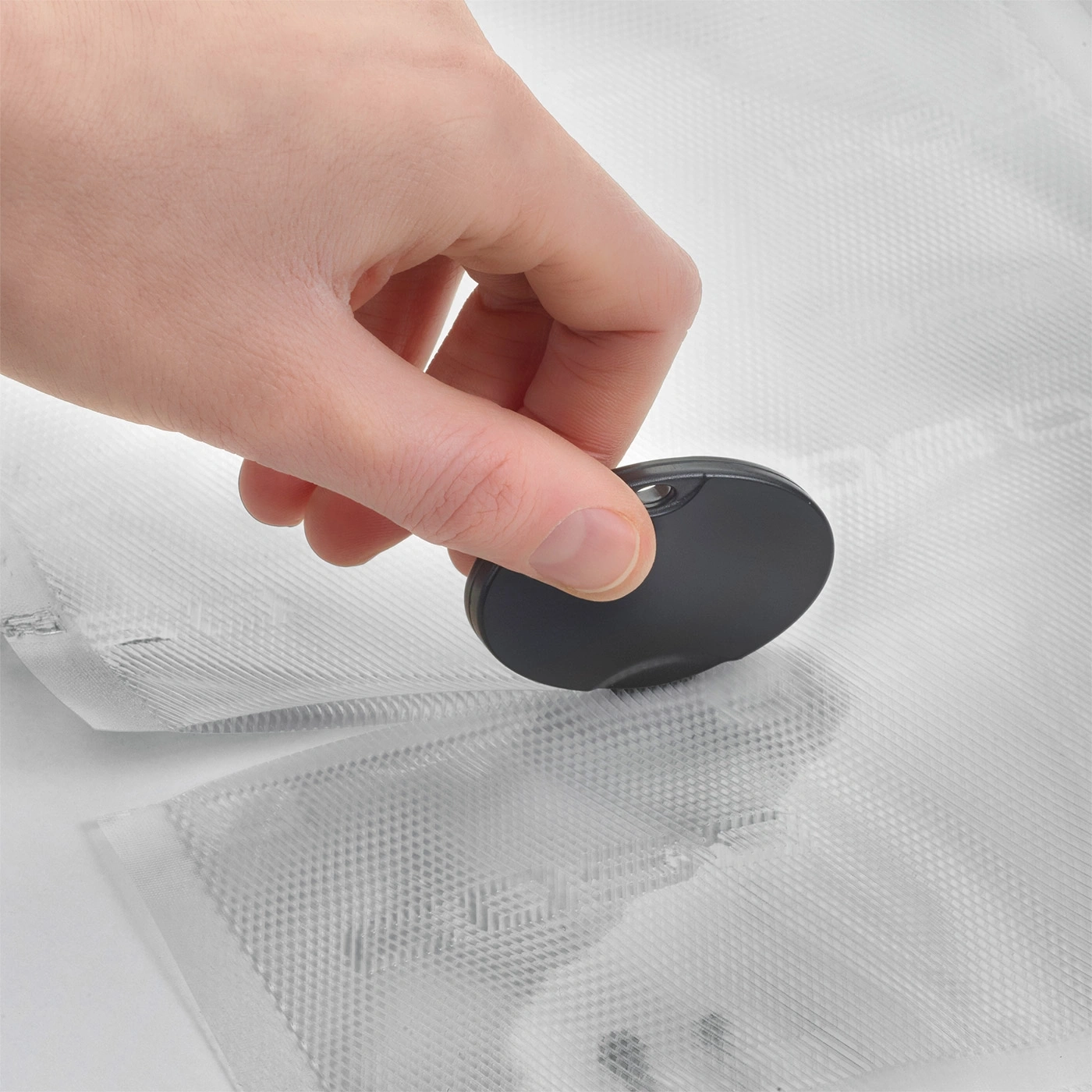 Hand holding sealing device for vacuum bags, close-up shot