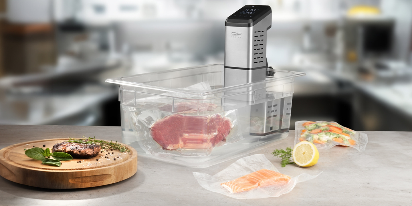 Sous vide machine with meat, vegetables, and fish, ready for cooking.