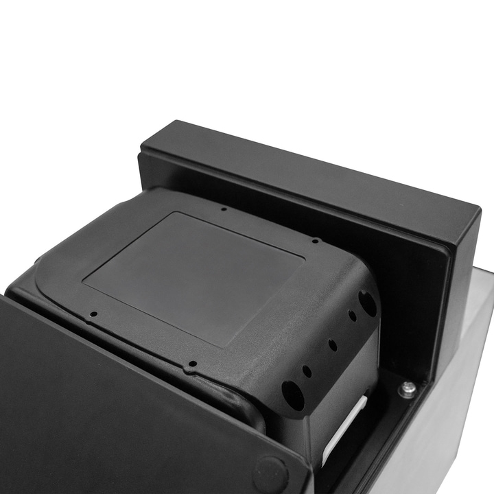Black device with holes and a rectangular display, close-up detail shot