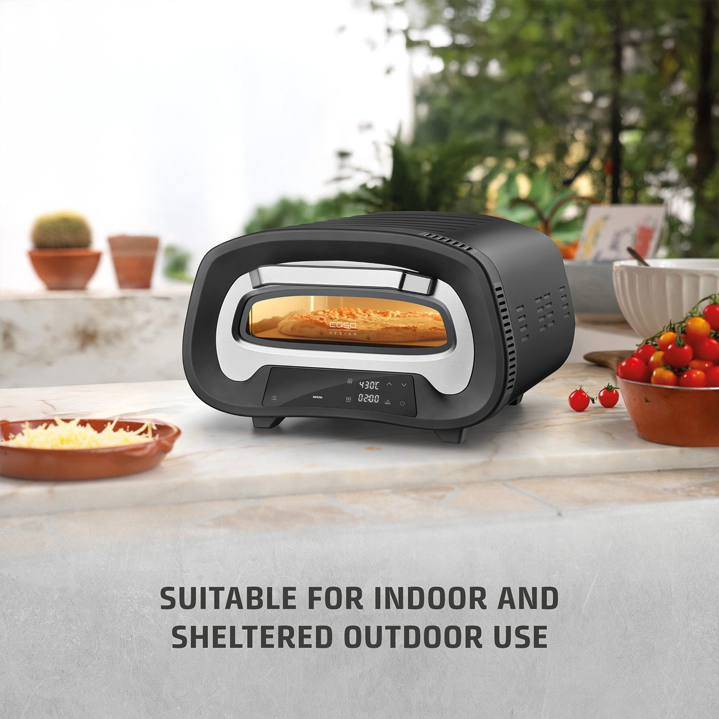 Pizza oven outdoors and indoors, with pizza and vegetables.