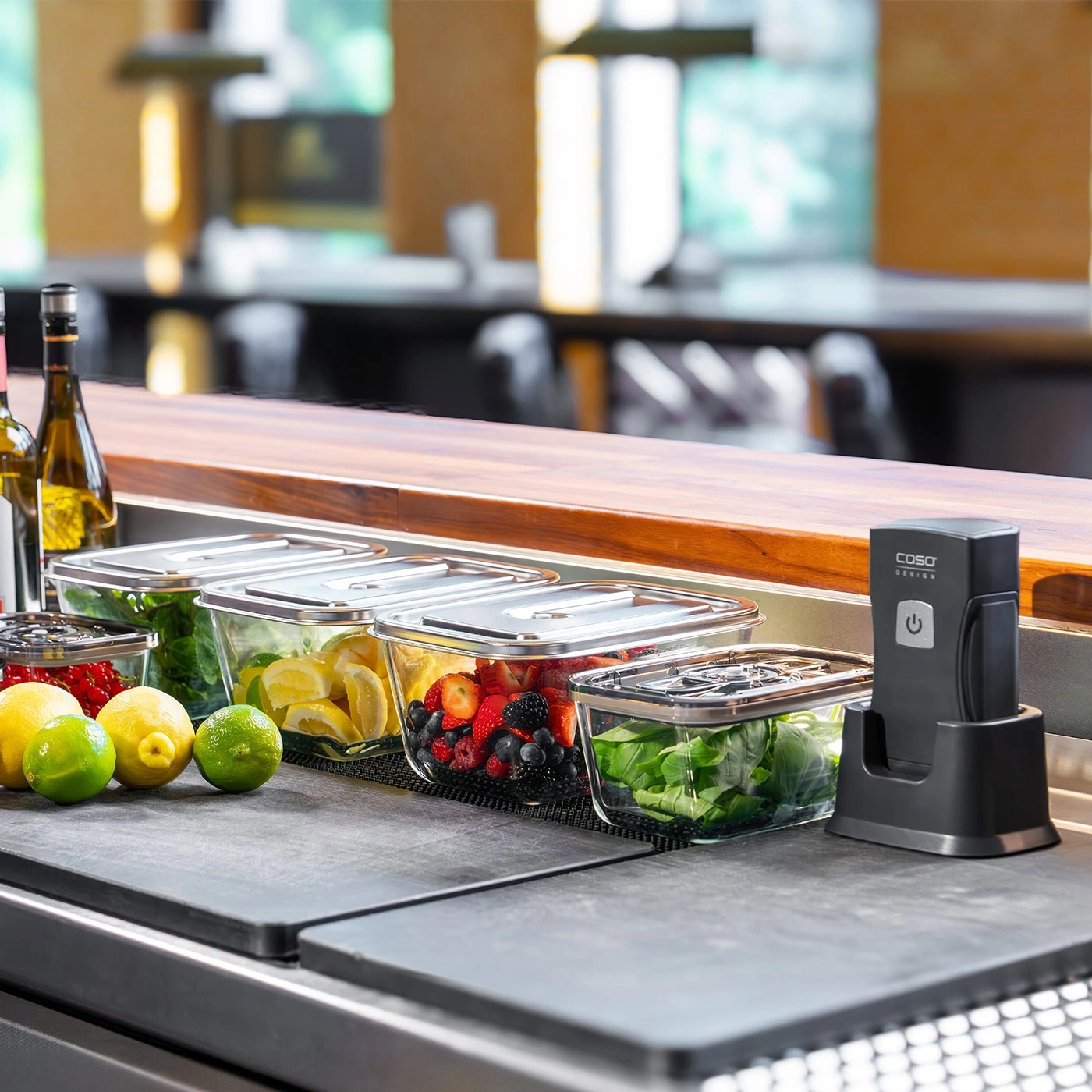 Fruits and vegetables in glass containers on a counter with a vacuum sealer.