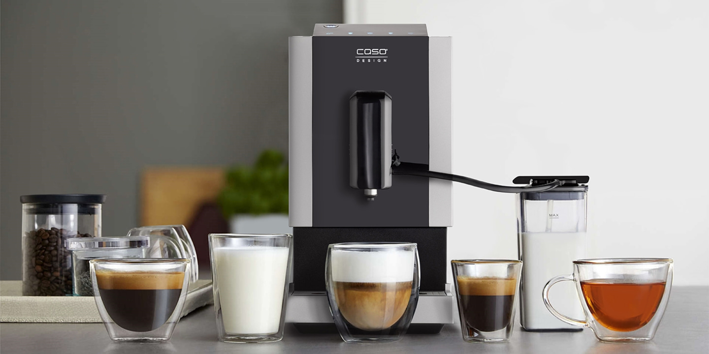 Coffee machine with various drinks, glasses, and a milk container.
