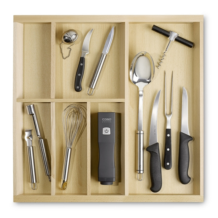 Kitchen utensils in a drawer: knives, whisk, spoon, corkscrew, and more.
