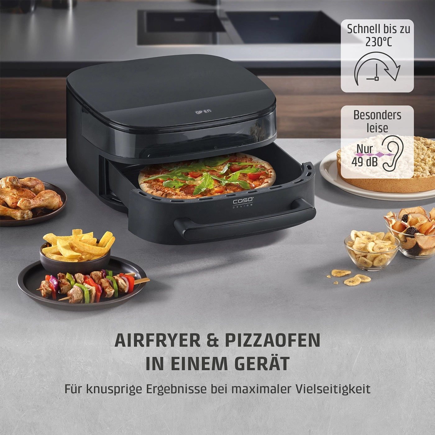 Ein schwarzer Airfryer und Pizzaofen mit Pizza, Hähnchen, Pommes und Kuchen.