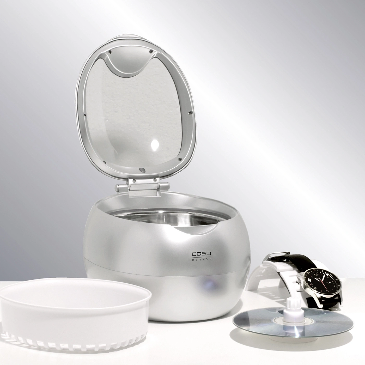 Silver cleaning machine with watch and CD. Caso Design. Open lid.