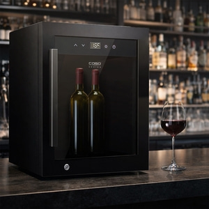 A black wine cooler with two wine bottles and a wine glass on the counter.