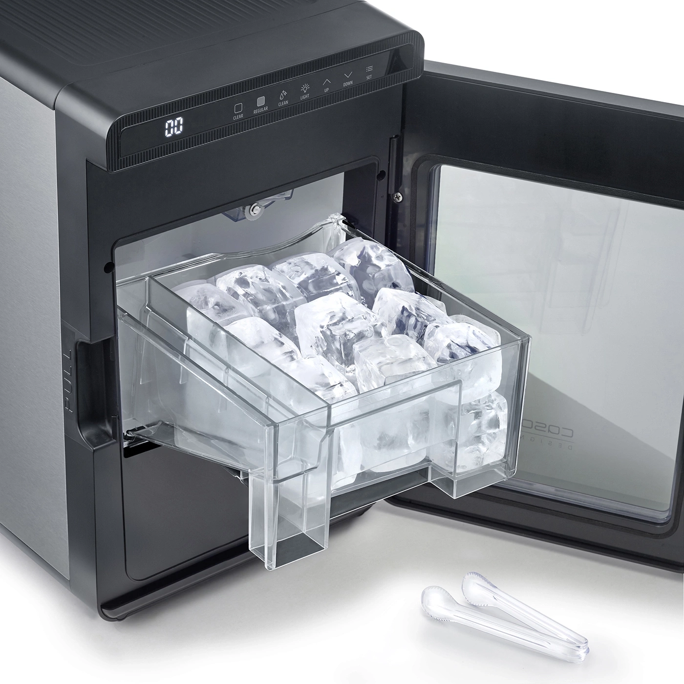 An ice maker with a full ice bin and small tongs