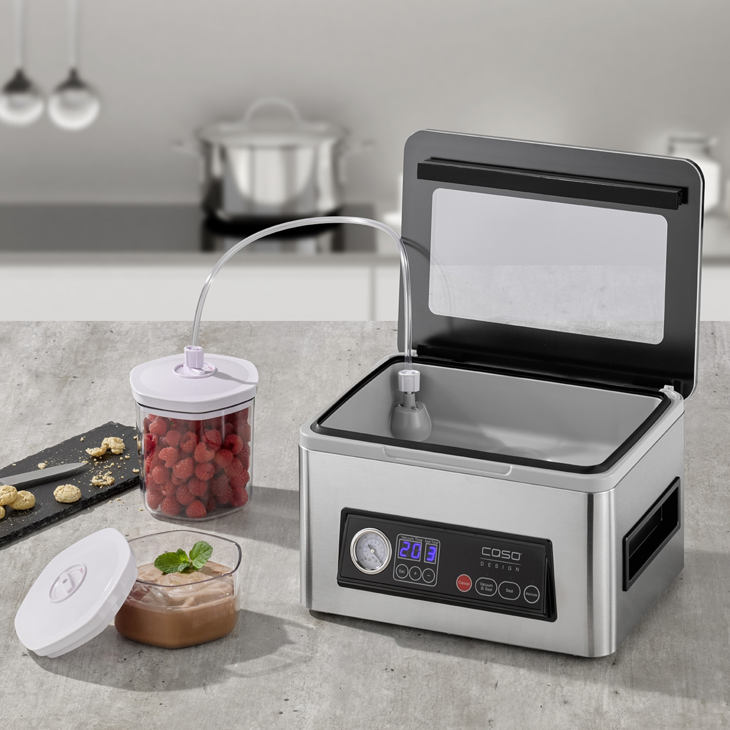 Vacuum sealer with containers and food on a kitchen countertop