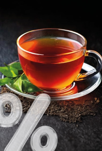 A cup of tea with percentage signs and tea leaves.