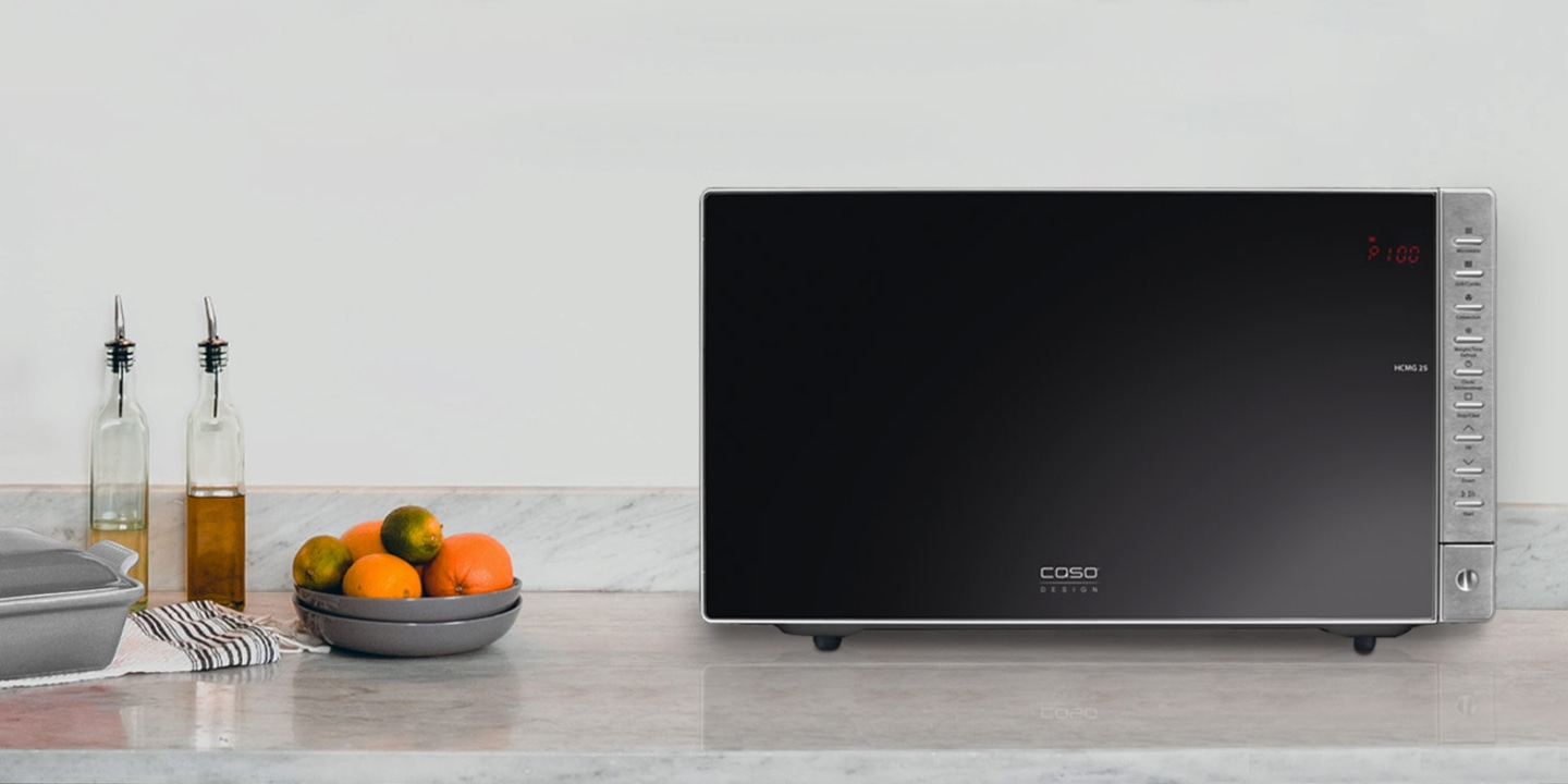 Microwave with fruit bowl on a kitchen countertop. Modern design and style.