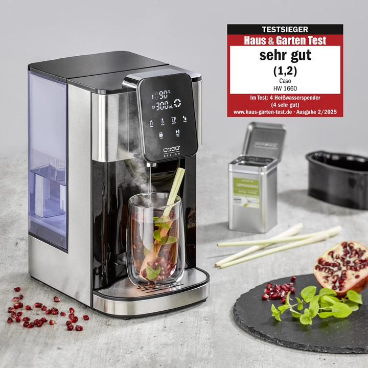 Hot water dispenser with glass, herbs, and pomegranate on a plate.