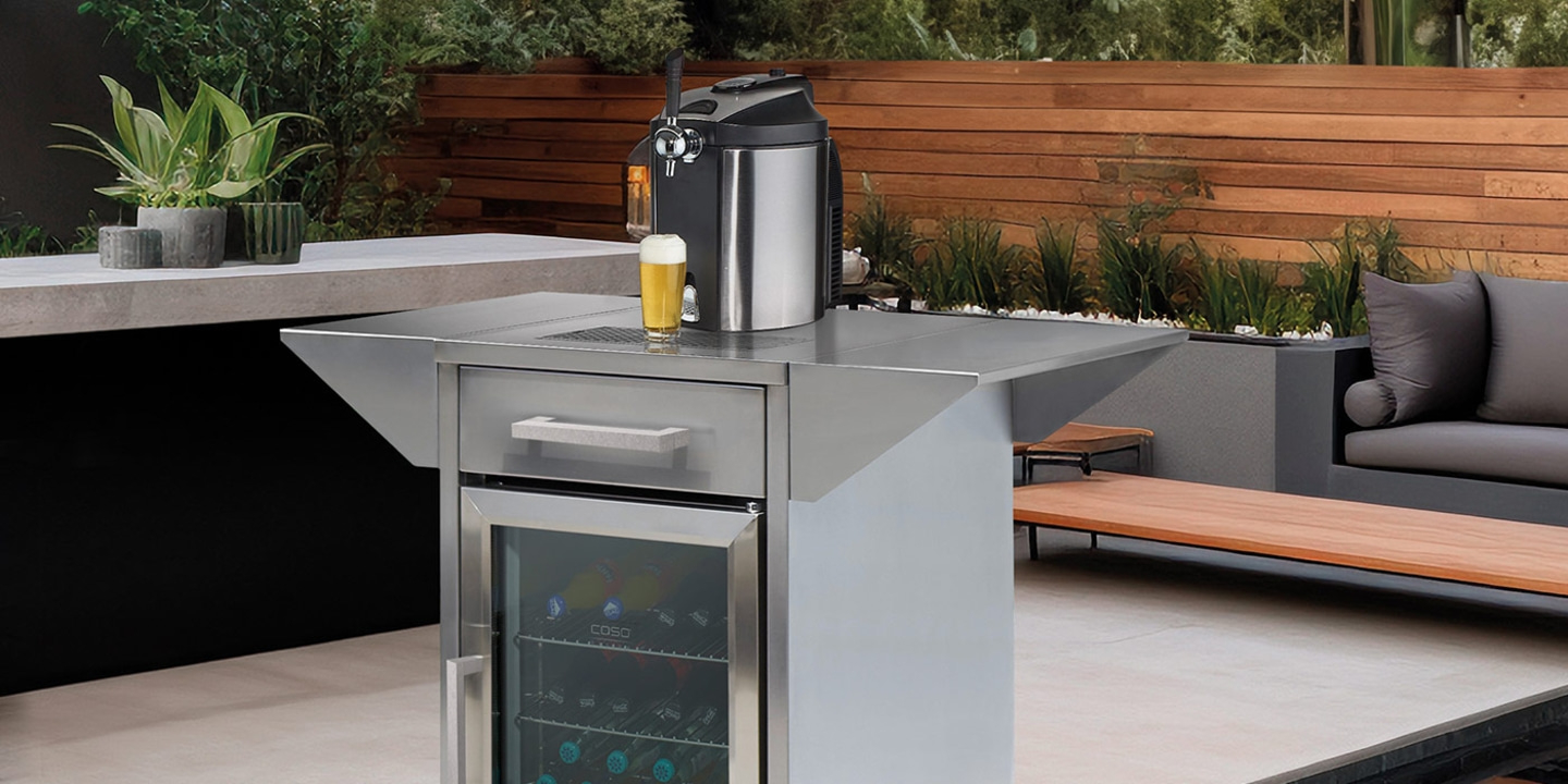 Outdoor patio with beer cooler, tap, and glass of beer on the counter