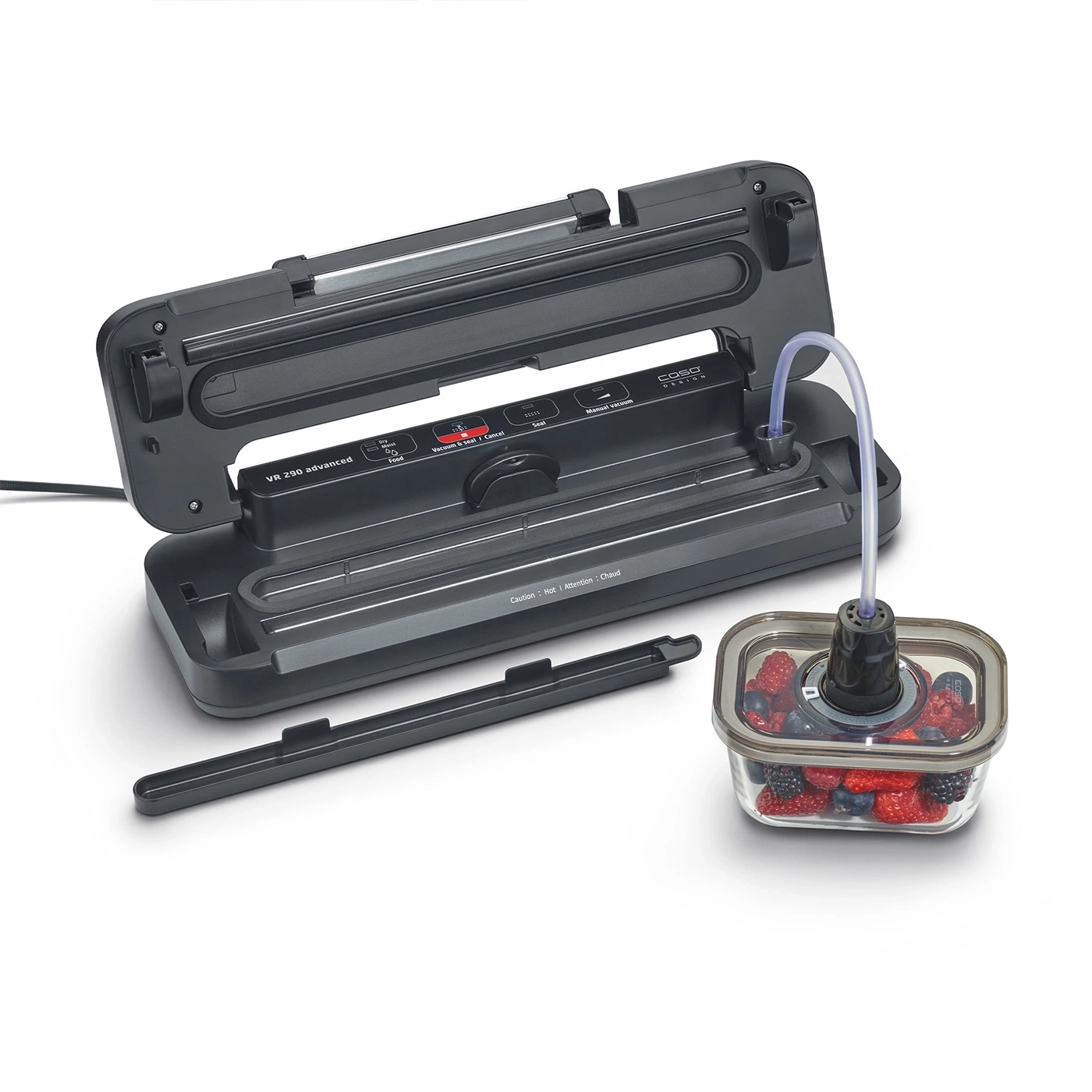 A vacuum sealer with berries in a glass container and a hose connected to a vessel.