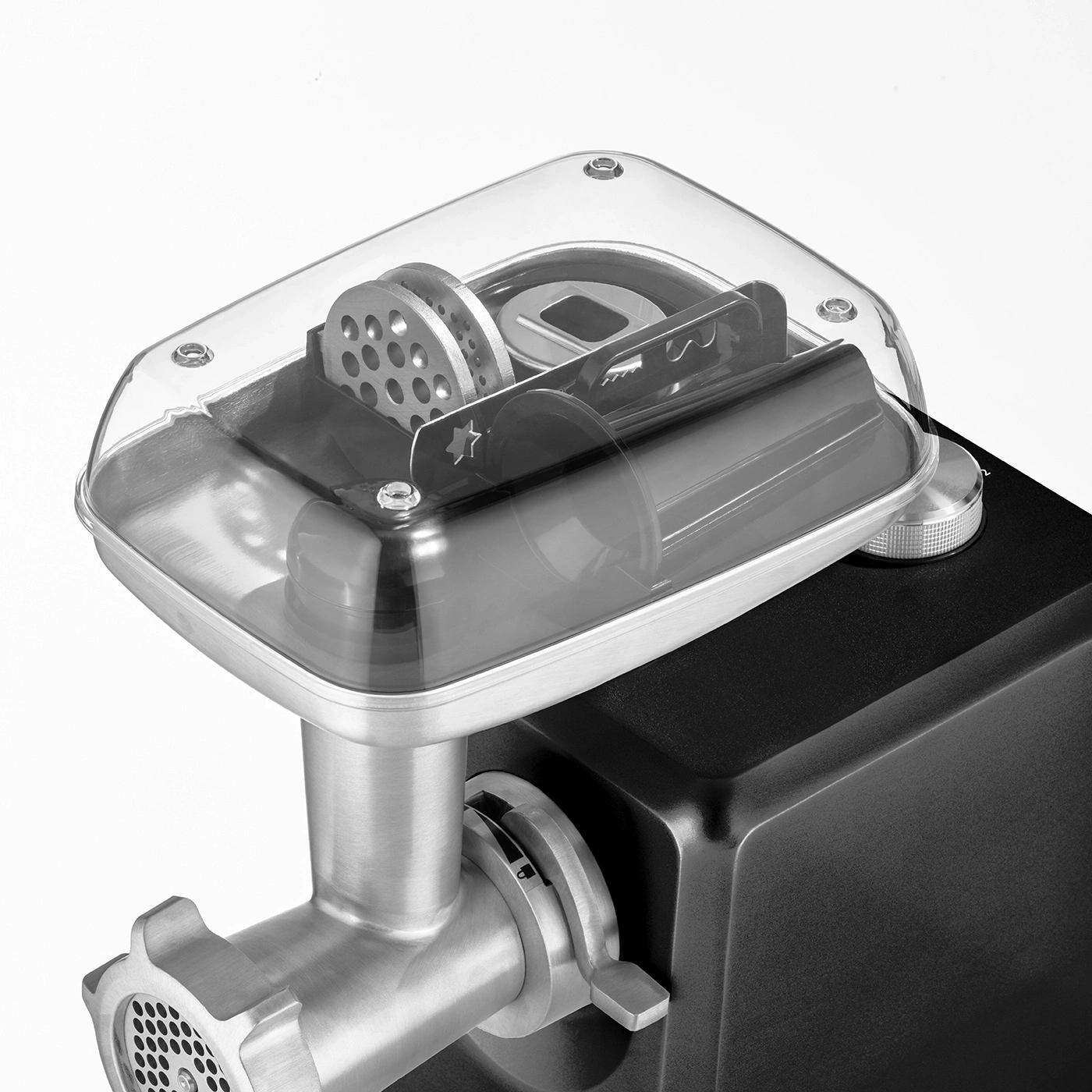 Meat grinder with transparent cover and accessories, close-up, black and silver