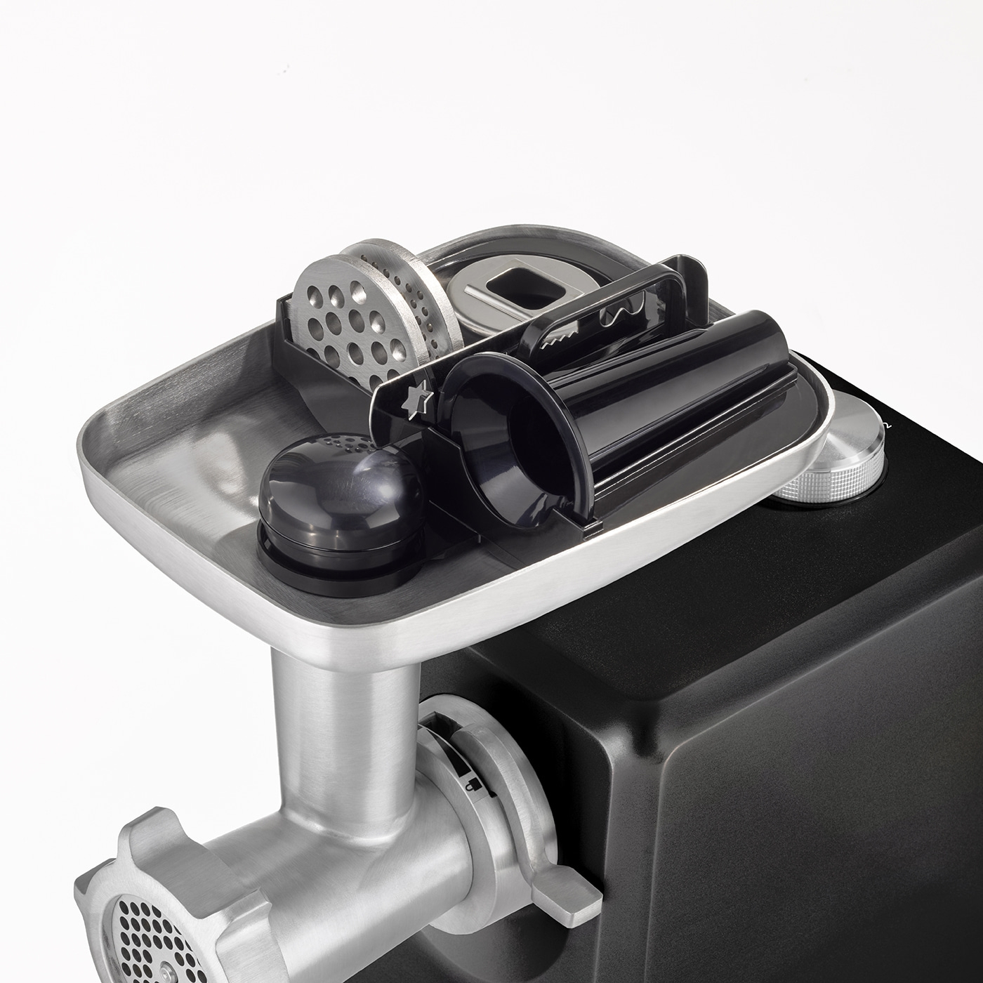 Meat grinder with accessories on white background, close-up, stainless steel