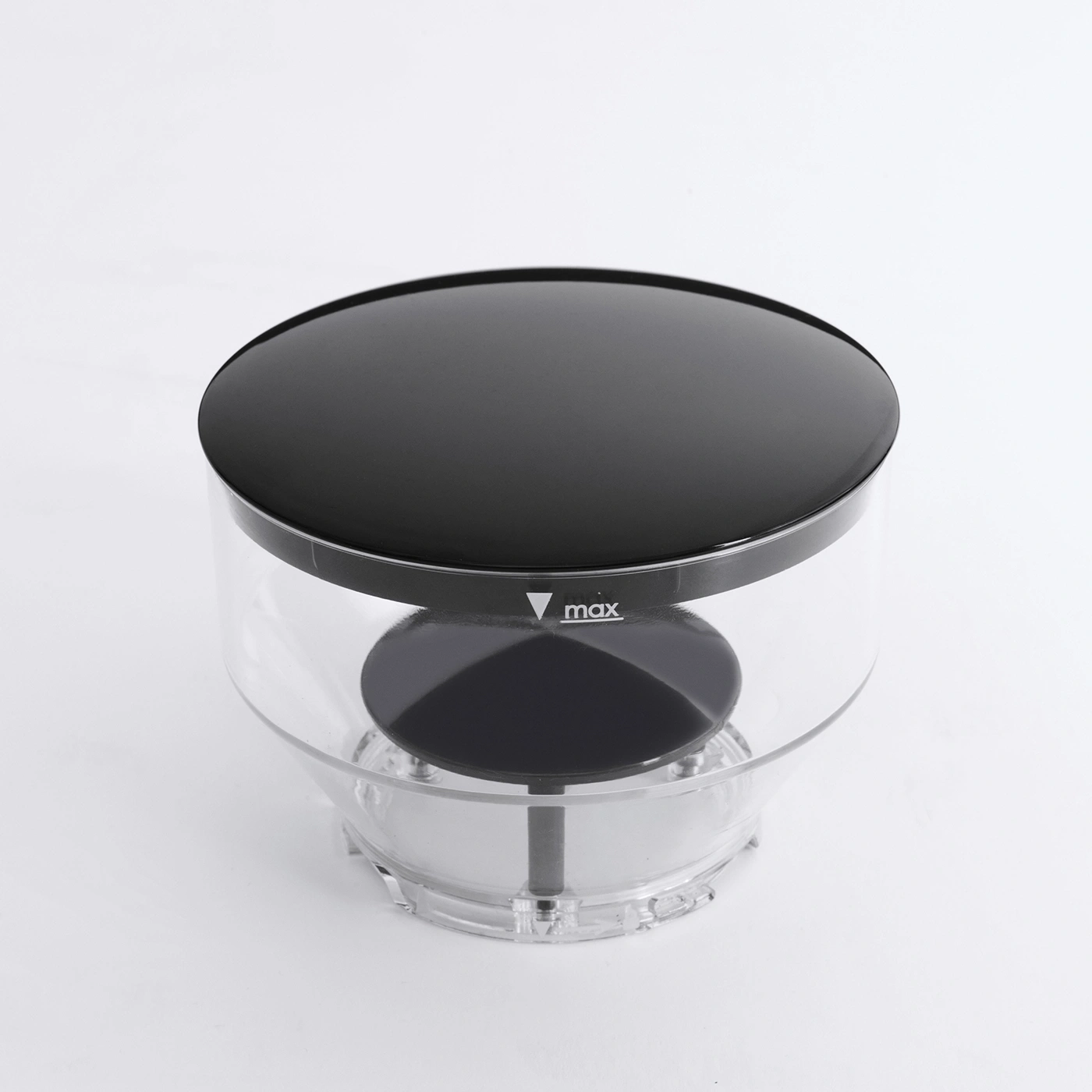 Black lid on transparent container with 'max' marking. Kitchen appliance. Clear plastic.
