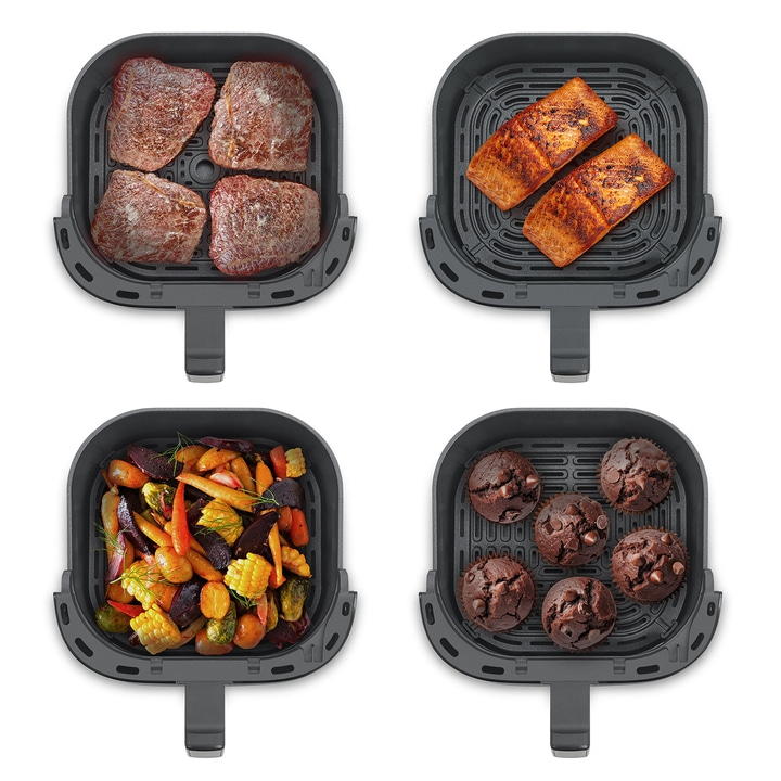 Air fryer with meat, fish, vegetables, and muffins. Cooking in the kitchen.