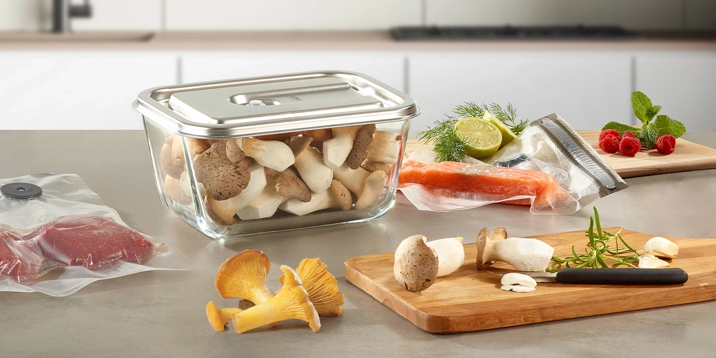 Fresh ingredients on a kitchen counter: mushrooms, fish, berries, herbs and more.