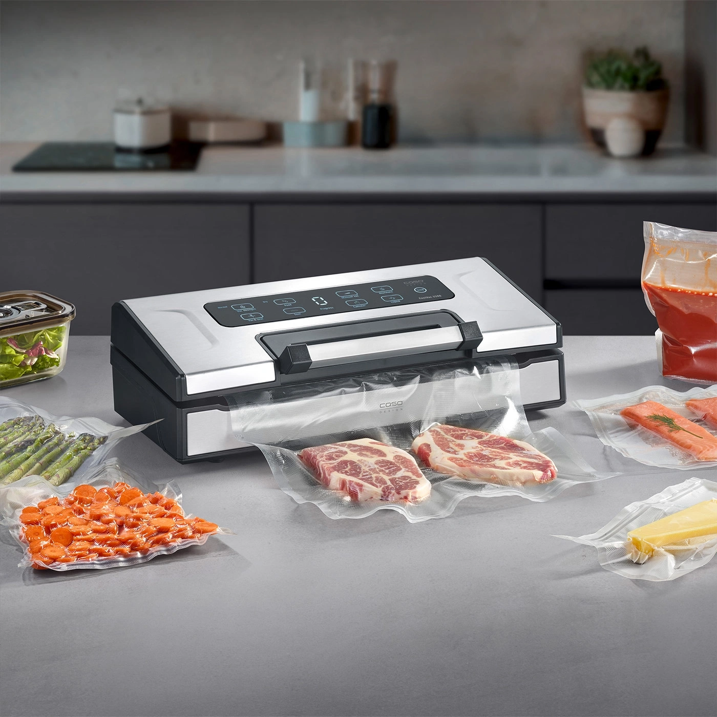 A vacuum sealer with various foods like meat, fish, vegetables, and cheese.
