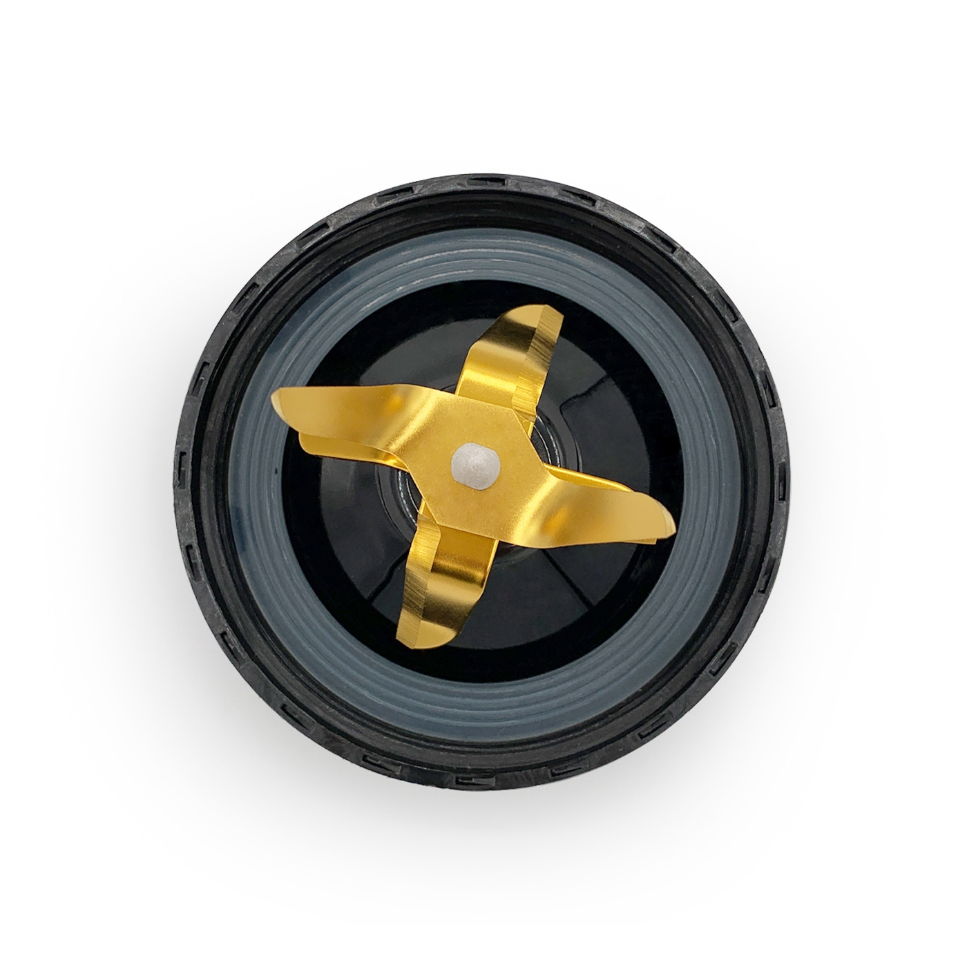 Close-up of a golden blender blade inside a black container