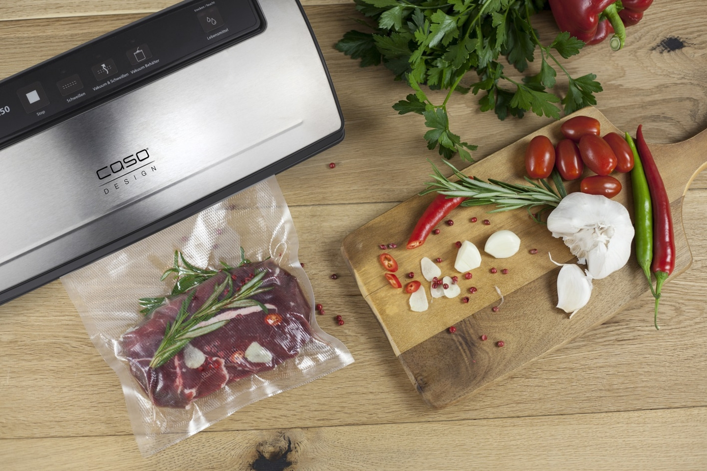 Vacuum sealer with meat, vegetables, and spices on a wooden board. Food packaging.