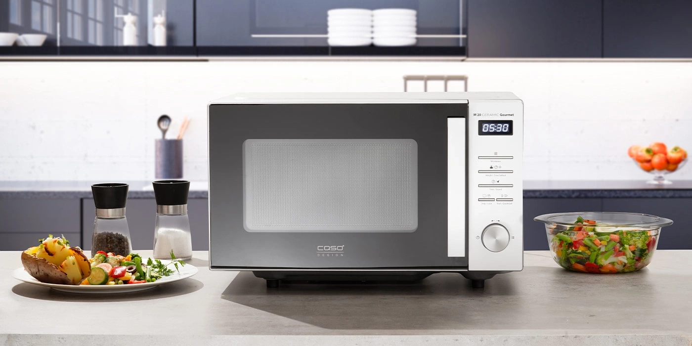 Microwave with food on the table in a kitchen. Food, microwave, kitchen.