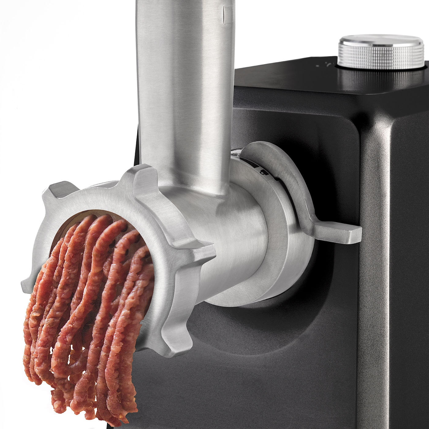 Meat grinder grinding meat, close-up, stainless steel, black background