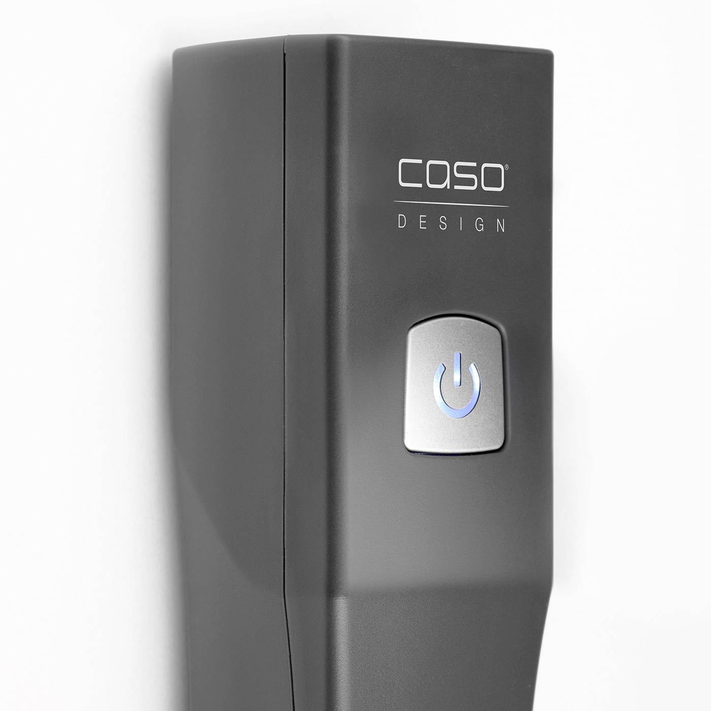 Gray device with logo and power button on white wall. Caso Design.