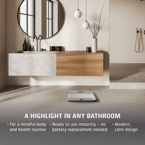 A scale in a modern bathroom with text overlay.
