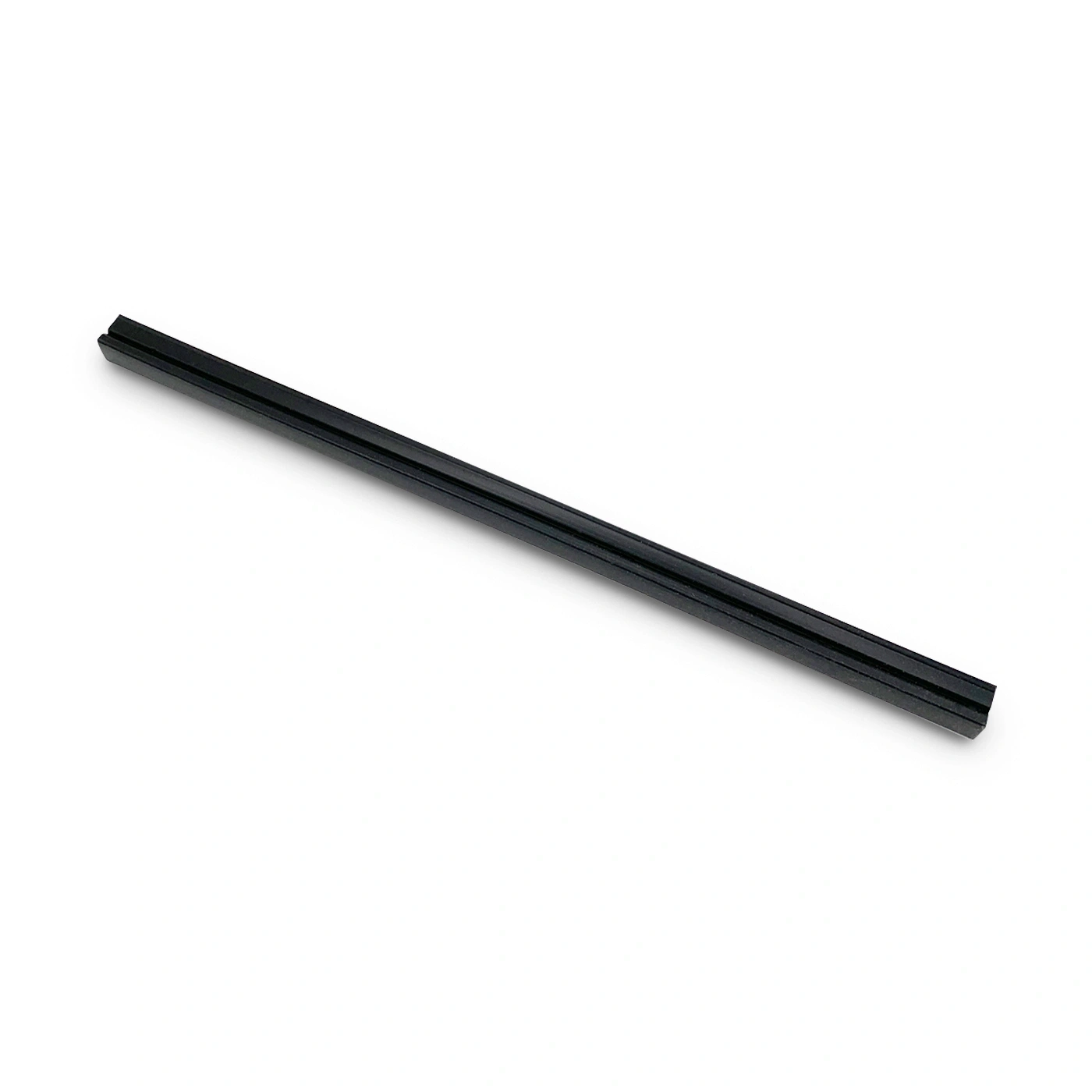 Black, elongated object on white background. Looks like a ruler or a similar item.