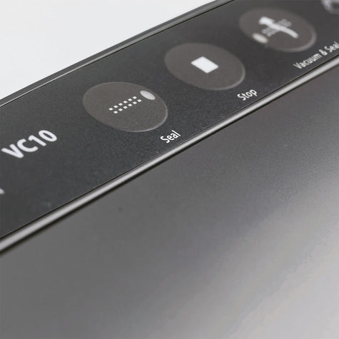 Close-up of a vacuum sealer's control panel, featuring 'Seal' and 'Stop' buttons.