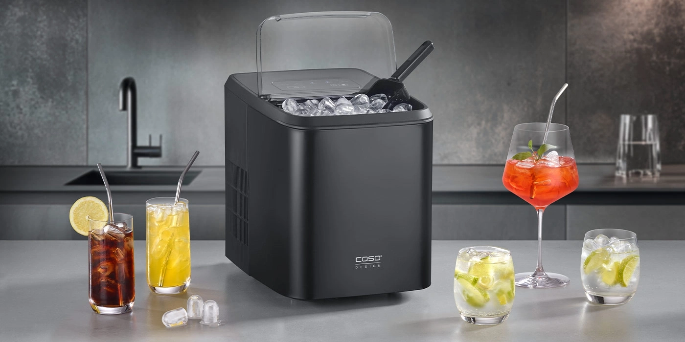 Ice maker with ice cubes and refreshing drinks on the countertop.