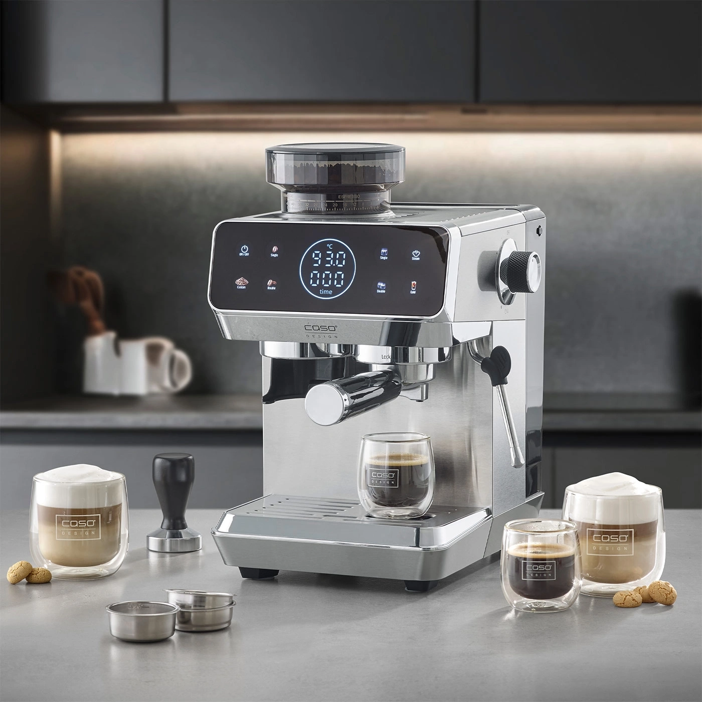 A silver espresso machine with a built-in grinder and two glasses of coffee.