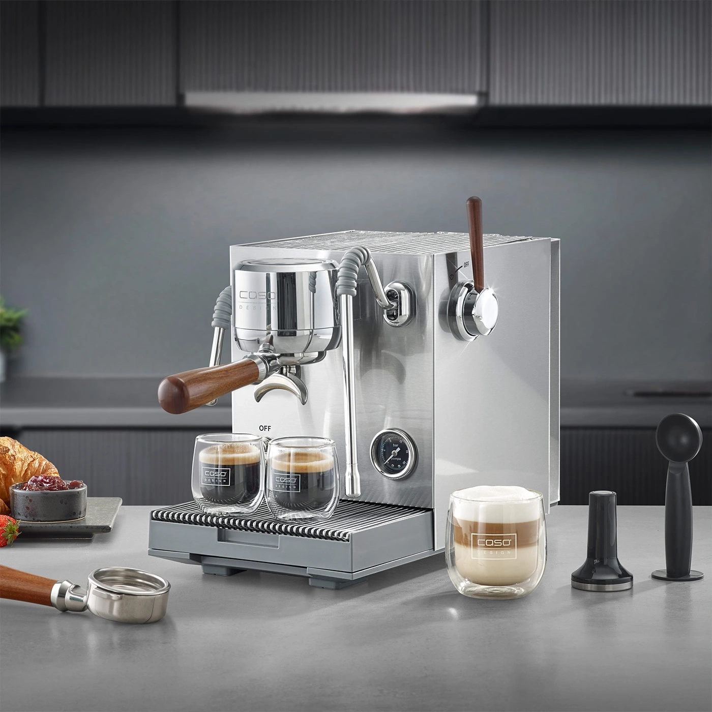 An espresso machine with two cups of espresso and a latte macchiato.