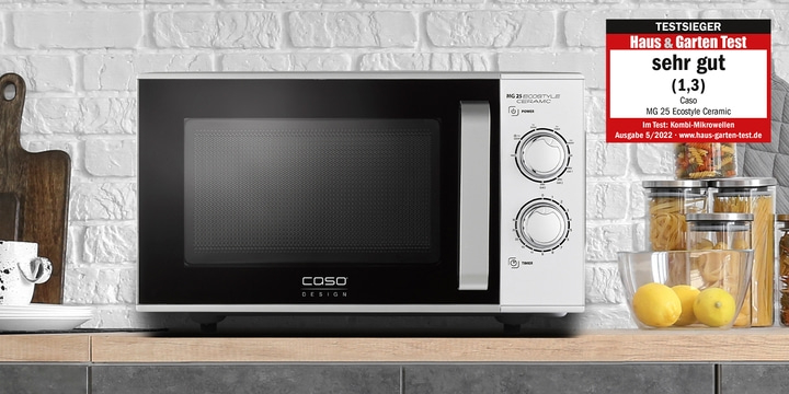 Microwave oven with 'very good' rating on a kitchen counter with accessories.