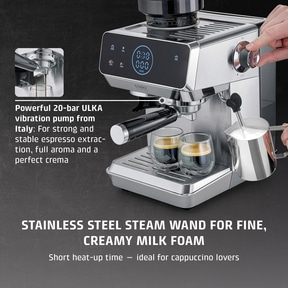 A silver espresso machine with two glasses and a milk frothing pitcher.